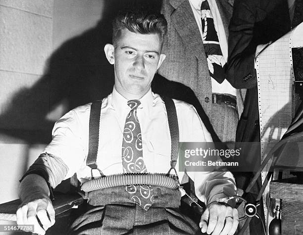 Los Angeles, CA; Eyes red-rimmed from a sleepless night, but declaring his "conscience clear," Robert M. "Red" Manly sits in a chair at police...