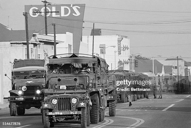 Los Angeles, CA: A convoy of trucks rolls into the Watts district loaded with National Guardsmen ordered in to the area to quell riots, now in to the...