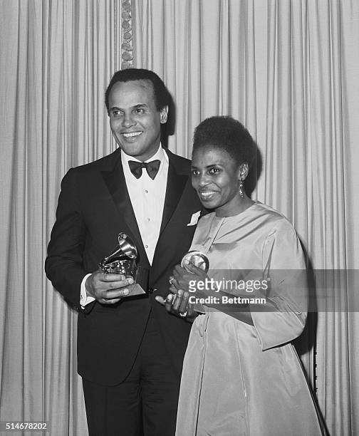 Portrait of Harry Belafonte and Miriam Makeba holding their Grammy awards for Best Folk Record. Belafonte and Makeba performed together on "An...