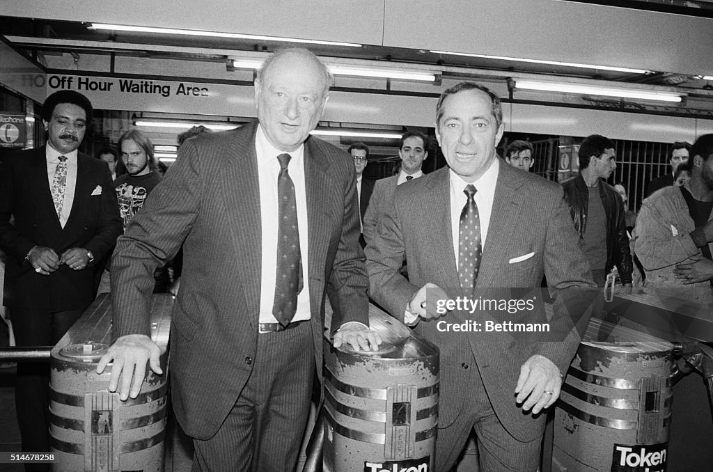 Koch And Cuomo Pass Through Turnstiles