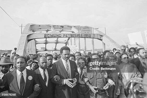 Many prominent civil rights activists cross the Edmund Pettus Bridge in a reenactment of the Selma to Montgomery march on the 20th anniversary in...