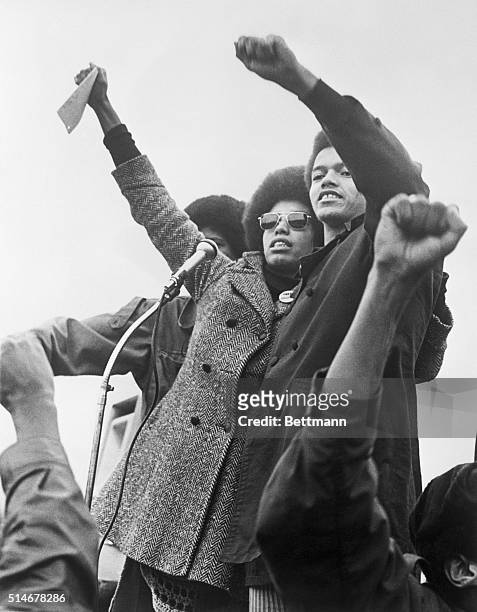 Activists Fania Jordan and Reginald Davis, relatives of Angela Davis, lead give the Black Power Salute at rally.