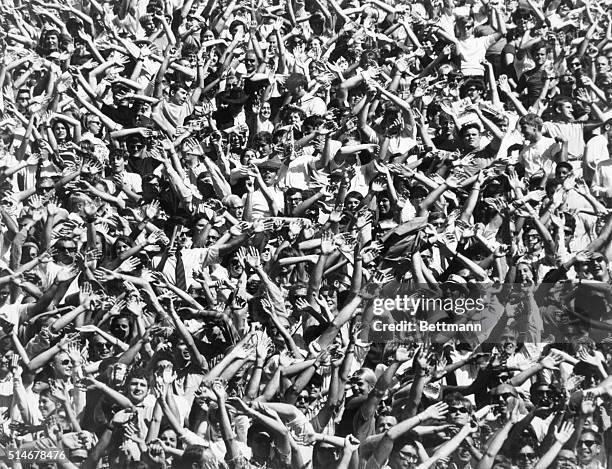 Football fans cheering as the University of Kansas Jayhawks score two touchdowns during a game against Syracuse, winning the game.