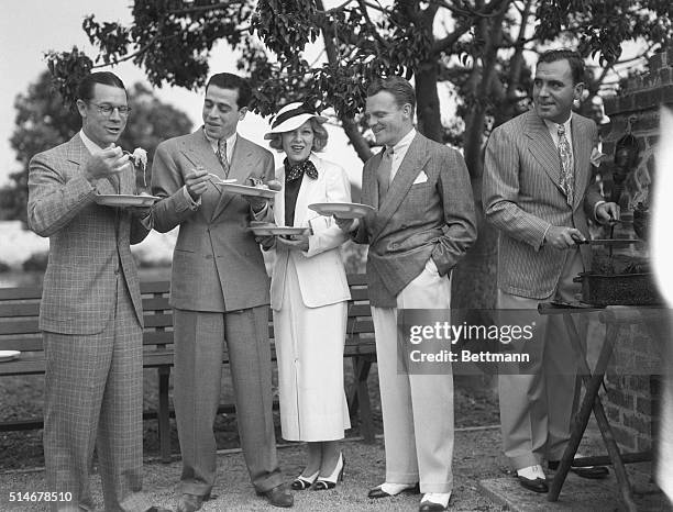 Joe E. Brown, Fred Keating, Glenda Farrell, James Cagney, and Pat O'Brien gather together for a barbecue on June 4, 1935. The film stars are at the...