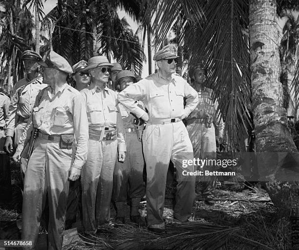 Leyte, Phillipine Islands: MacArthur with Colonel Iehrbas, Sergio Osmena and Brg. Gen. Romulo on Leyte. Mac's trousers are wet to knees after wading...