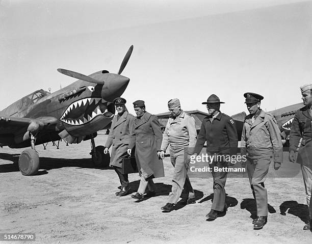 Meeting at an airbase in China are Sir John Dill, British Field Marshal, Brigadier General Claire Chennault, Lieutenant General Henry Arnold,...