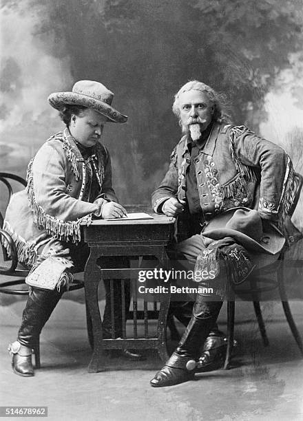 Colonel William Frederick Cody, also known as Buffalo Bill, sits across from his friend Colonel G.W. Lillie, or Pawnee Bill, as he writes.