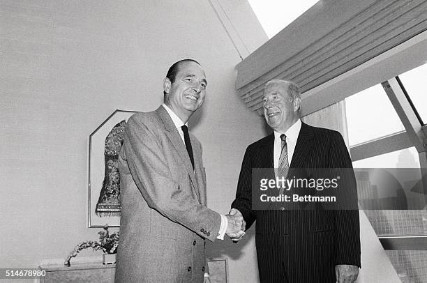 France's Prime Minister Jacques Chirac shakes hands with U.S. Secretary of State George Shultz during luncheon hosted by Chirac at U.N. Plaza Hotel....