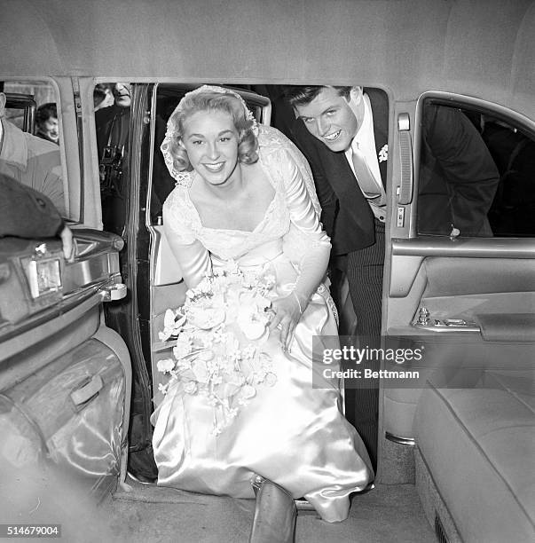 Edward Kennedy and his bride, the former Joan Bennett, step in to their car after their wedding.