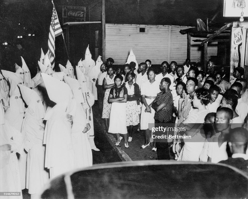 A Group Of African Americans Confront A Members Of The Ku Klux Klan a-group-of-african-americans-confront-a-members-of-the-ku-klux-klan