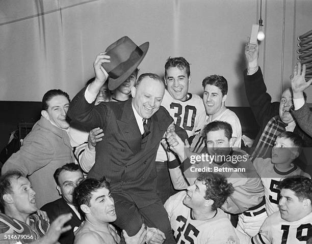 Washington: Jubilant Chicago Bears hold aloft their owner-coach, George Halas, after they snowed under the Washington Redskins, 73-0, at Washington,...