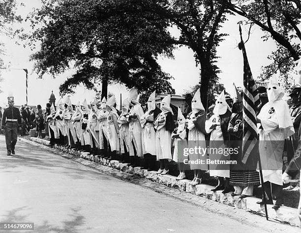 Ku Klux Klansmen and their families stand along the driveway of Oakland Cemetery in Atlanta during a memorial service for the Confederate States' war...