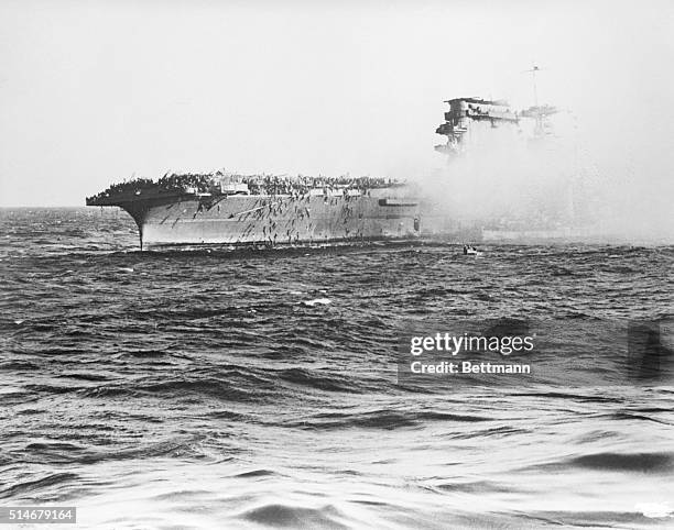 Washington, D.C.: Men swarm over the side of the aircraft carrier U.S.S. Lexington on the captain's order to abandon ship, after it was hit by Japs...