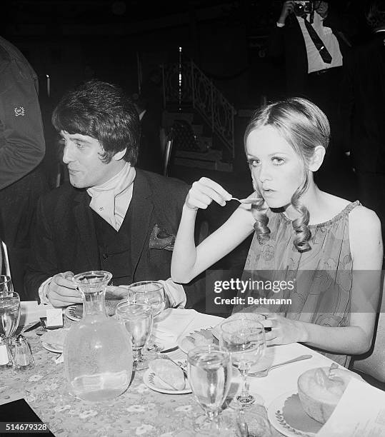 The fashion model Twiggy nibbles on piece of cantaloupe at the Champetre dinner for the Benefit of the Fountain House at the Waldorf Astoria in 1967.