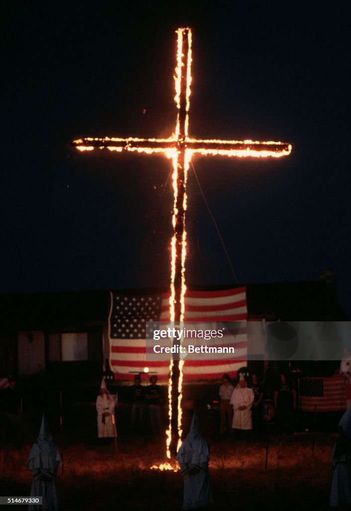 Ku Klux Klan Members Burning a Cross