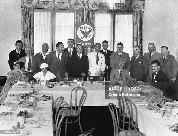 Group of prominent writers join together at a banquet to form the Authors' Legion, a branch of the National Recovery Administration. Standing, left...