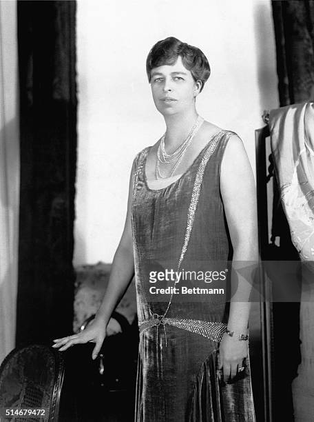 Picture shows Eleanor Roosevelt, wife of President Franklin Delano Roosevelt, posing for a portrait. She is shown wearing a long velvet dress with a...