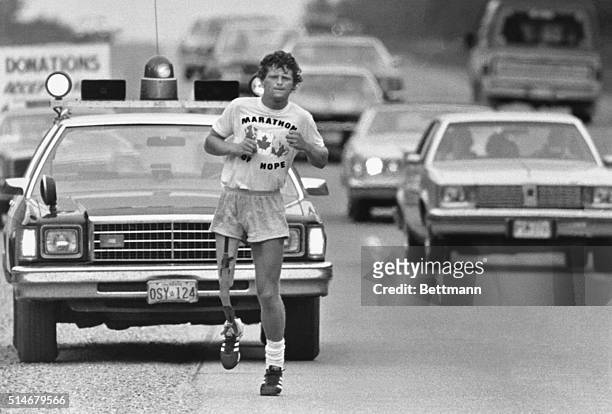 Terry Fox, age 22, is running coast-to-coast across Canada on an artificial limb, after losing his right leg to cancer three years ago, in an effort...