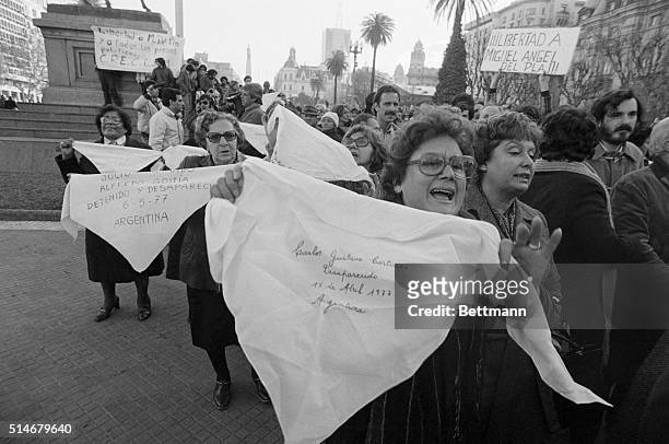 Women march through the streets of Buenos Aires, displaying handkerchiefs with the names of relatives who have disappeared since 1975. Thousands of...
