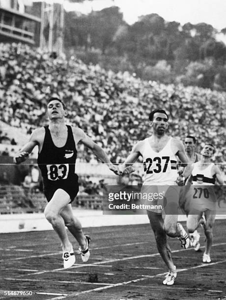 New Zealander Peter Snell crosses the finish line ahead of Belgian Roger Moens in the 800-meter run at the 1960 Summer Olympics in Rome, Italy.