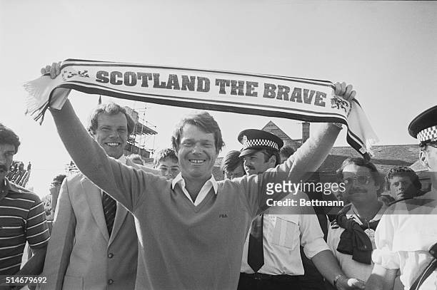 Golfer Tom Watson raises a scarf in victory, celebrating his win of the 1982 British Open in Troon, Scotland.