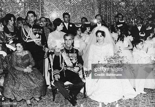 Mohammed Reza Pahlavi, the Shah of Iran, has just married his third wife Farah Diba. The Shah's mother is seated left of him, with his brother Golem...