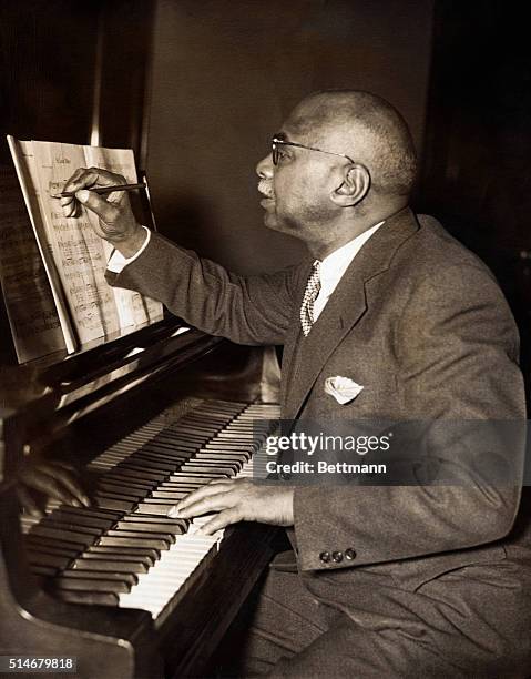 Composer W.C. Handy makes notations on sheet music while creating St. Louis Blues.