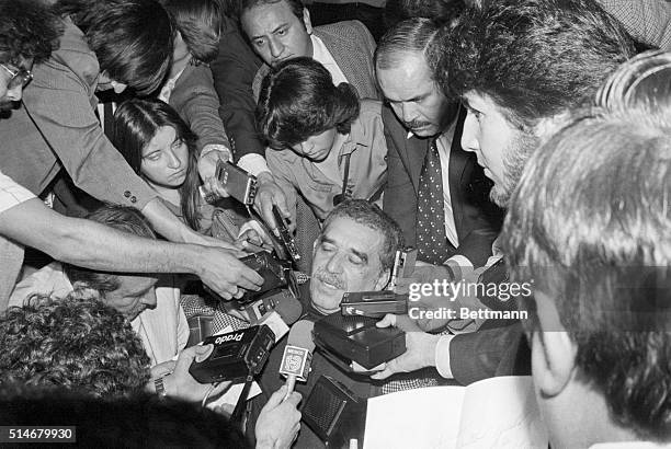 Mexico City, Mexico: Colombian left-wing novelist Gabriel Garcia Marquez is surrounded by Mexican newsmen with tape recorders and microphones after...