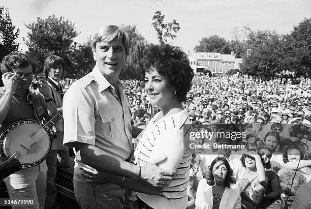 Middleburg, VA: Senator John Warner and his wife, actress Elizabeth Taylor, appear to be sharing a private moment while greeting a large crowd of...