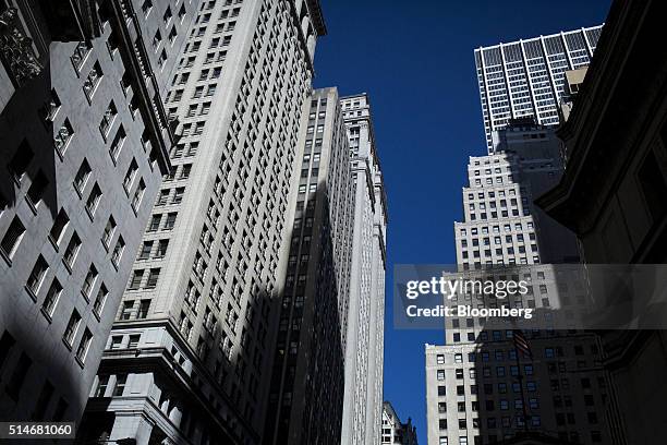 Buildings stand on Wall Street near the New York Stock Exchange in New York, U.S., on Monday, Feb. 22, 2016. Stocks retreated with government bonds,...