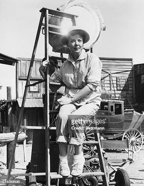 Film star Ida Lupino, wearing jeans and sneakers, sits on a ladder while directing a Western, "The Only Man in Town" for CBS television's weekly...