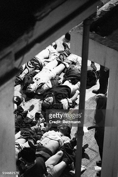 Many corpses, overflow from the morgue, lay on a police station patio after a soccer game stampede in Buenos Aires that killed 71 people.