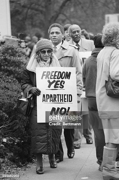 Civil rights heroine Rosa Parks carries a sign outside the South African Embassy in Washington. It reads "Freedom Yes, Apartheid No!" | Location:...
