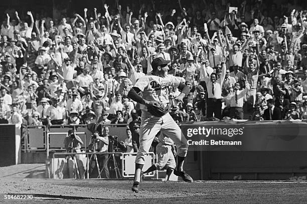 Pitcher Sandy Koufax and the crowd in the stands erupt with joy at the Los Angeles Dodgers victory in the 1963 World Series.