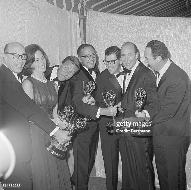 The actors, screenwriters, director and producer of "The Dick Van Dyke Show" show off the awards the show won in the 1964 Emmy Awards.