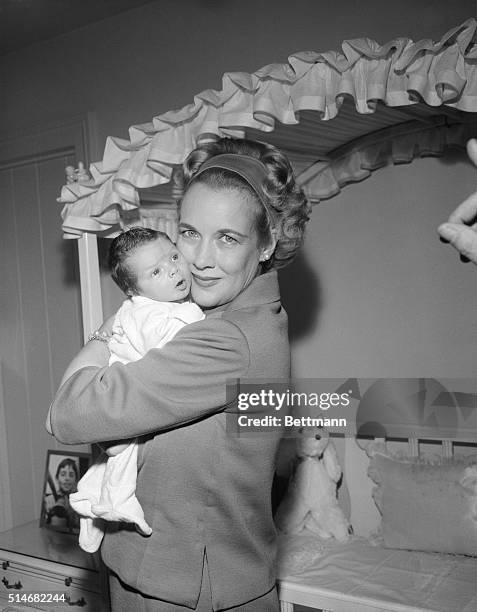 Kay Gable hugs her two week old baby, John Clark Gable. The baby, son of the late actor Clark Gable, was born in the very hospital where Gable died...