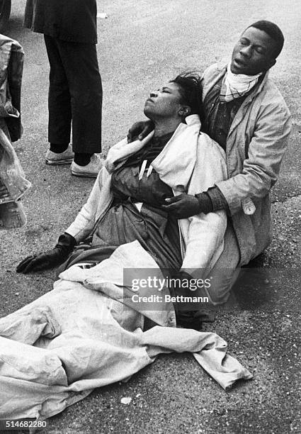 Civil rights marcher suffering from exposure to tear gas, holds an unconscious Amelia Boynton Robinson after mounted police officers attacked...