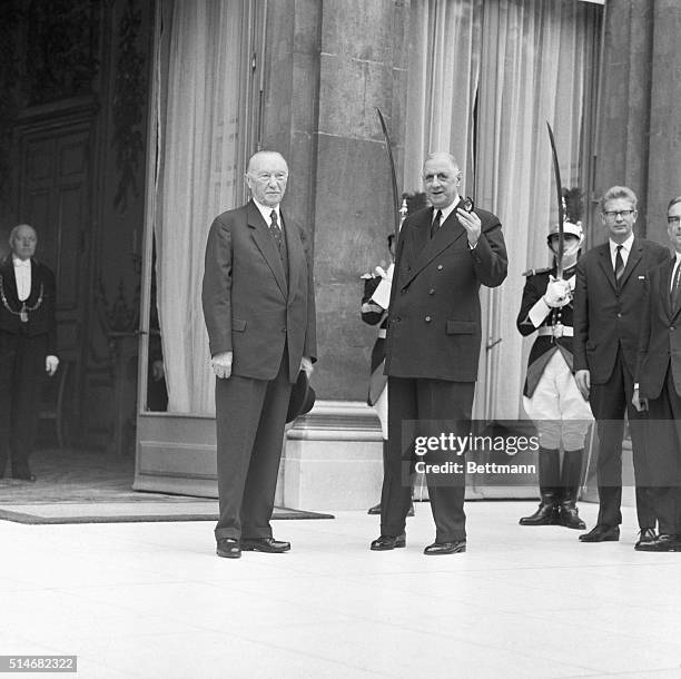 Charles De Gaulle talks with West German Chancellor Konrad Adenauer in front of the Elysee Palace in Paris.