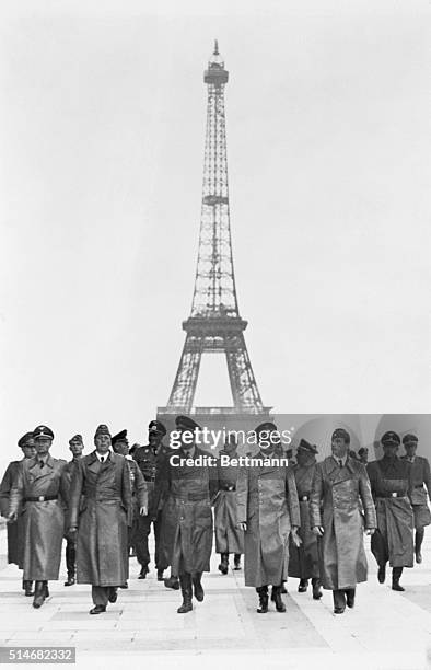 France: The famous Eiffel Tower, symbol of the city of Paris, is pictured in the background as Hitler and his party go sightseeing through the...