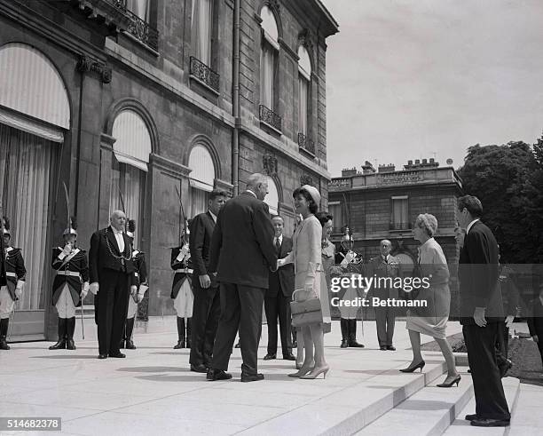 President De Gaulle of France welcomes First Lady Jackie Kennedy to the Elysee Palace. Madame De Gaulle, Protocol chief De Courcier and President...
