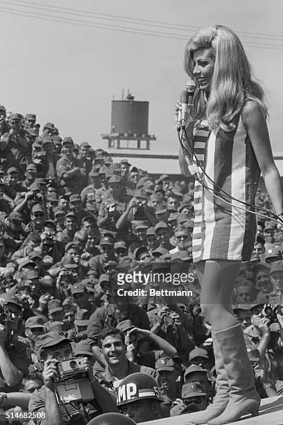 Singer Nancy Sinatra performs for members of the First Infantry Division in Bien Hoa, South Vietnam.