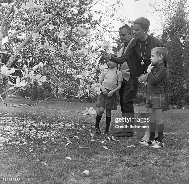 Prince Rainier and Princess Grace of Monaco look at tree blossoms with their son Albert and their daughter Caroline while on vacation in Philadelphia.