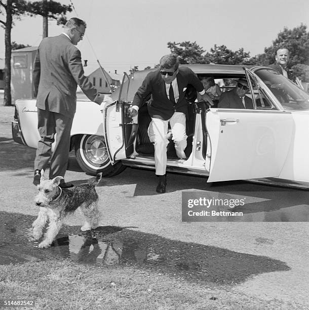 President John F. Kennedy chases Charlie, his daughter's Welsh terrier, as it runs away. The Kennedys are visiting the First Lady, while she is in...