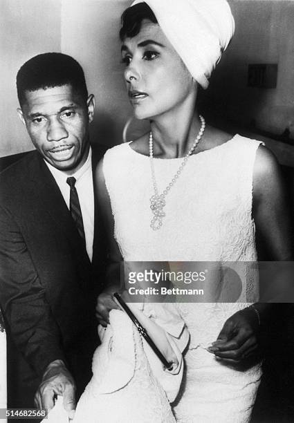 Portrait of State Field Representative Medgar Evers escorting singer Lena Horne to a civil right rally in Jackson, Mississippi.