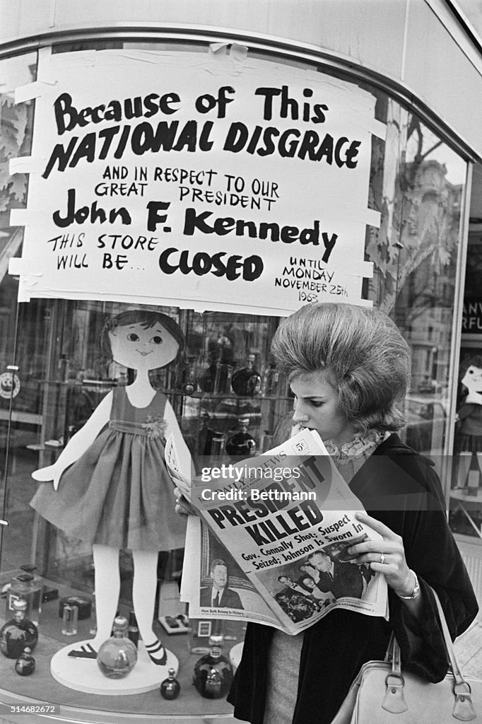 Woman Reading About President Kennedy's Assassination