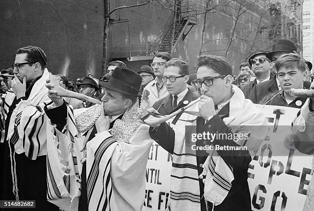 New York: Dressed in religious robes, two men blow symbolic reminder of the Battle of Jericho and the collapsing wall before a massive march around...