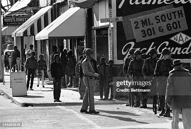 South Carolina National Guardsmen patrol the streets of Orangeburg, South Carolina after three African American students were killed during race...