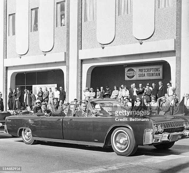 President John F Kennedy and Texas Governor John Connally ride in a convertible in a motorcade in Dallas on November 22, 1963 moments before a...