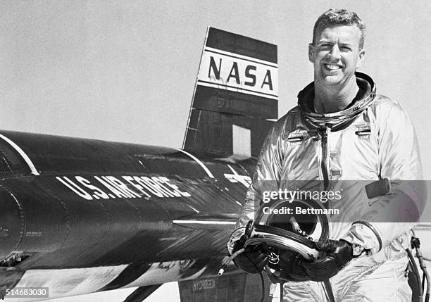 Test pilot Joseph A. Walker smiles as he stands beside an X-15 rocket plane in which he flew at a record breaking altitude of 165,000 feet and a...