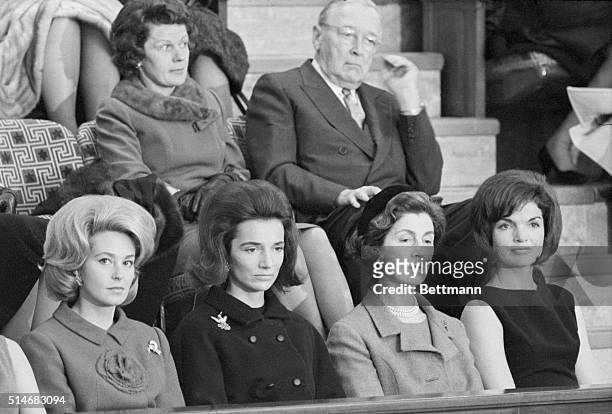 First Lady Jackie Kennedy watches President Kennedy deliver the State of the Union address. Among those watching with her is her mother, Janet...